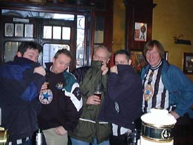Team photo, after being asked to "Cover up " in a no - colours pub.