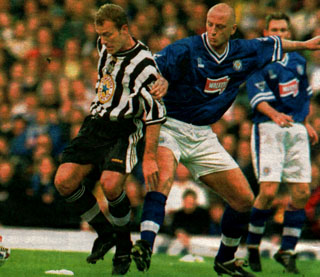 Shearer gets the better of Elliot.