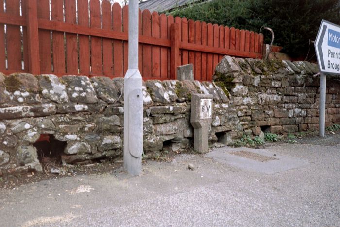 Firing loop-holes in a wall at Eamont Bridge.