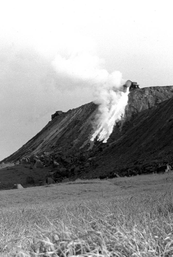 A slag-engine disposes of its load of slag.