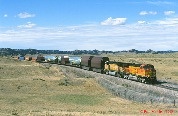 BNSF Dash 9-44CW #5442 + #4567 at the Lower Horseshoe, Crawford with skyboxes and aircraft fuselages as part of a W/B intermodal - Sept 2002