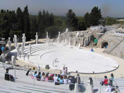 The Greek Theatre at Syracuse, before the performance, showing huge Cycladic figures that surounded the stage.