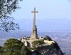 Large stone cross on a nearby outcrop.