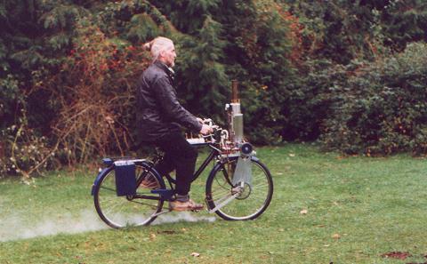 Geoff rides the steam bicycle