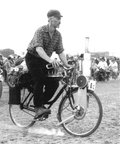 Geoff rides the steam bicycle