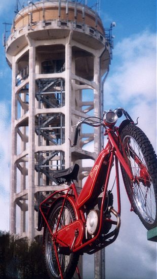Bown autocycle in front of water tower