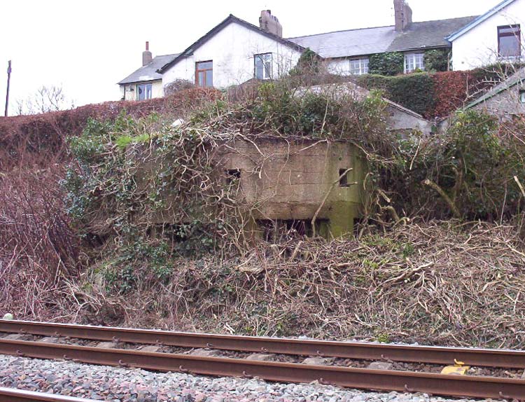 One of Barrow's unique corner-loop-holed pillboxes guards a railway.
