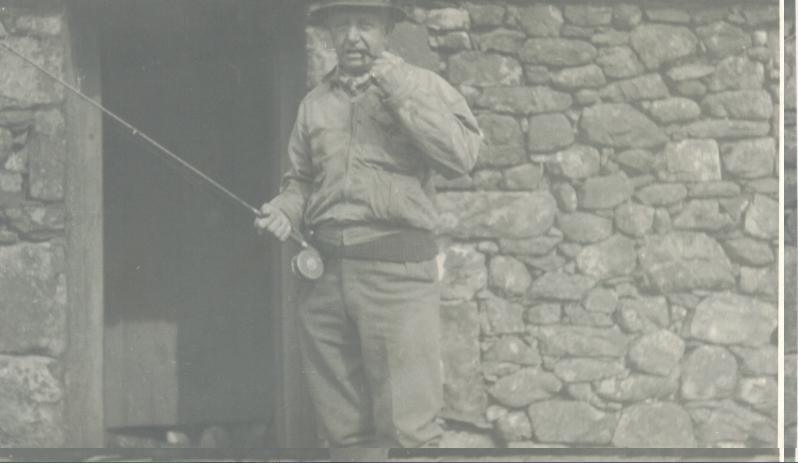 Captain W Ward-Hunt on his day off outside a hut at Devoke Water