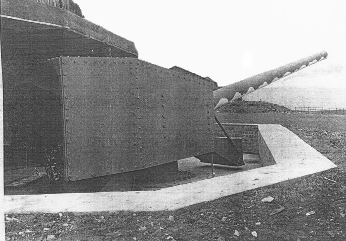 One of the 138mm French guns on the WWII Whitehaven coast battery, Haig pit chimney billowing smoke in the background.