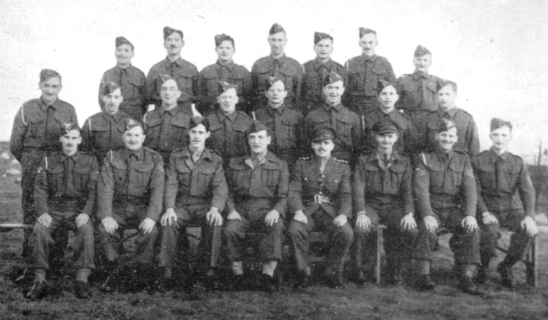 A group of regular and Home-Guard gunners pose for a photograph.